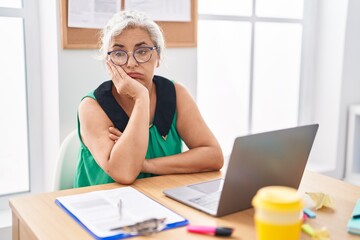 Canvas Print - Middle age grey-haired woman business worker stressed using laptop at office