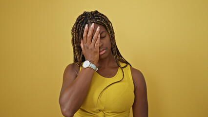 Wall Mural - African american woman stressed standing over isolated yellow background