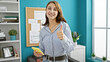 © Krakenimages.com - Young woman business worker using smartphone doing thumb up gesture at the office