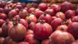 © Alex Puhovoy - Pomegranate. Red ripe pomegranate. Lots of fruits in a street stall. Selective focus. AI generated