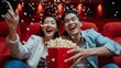 © Zahid - Happy trip of asian couple sweet sit togather on red seat and looking movie in cinema with fun a popcorn on hand, people relax and holiday activity on a weekend
