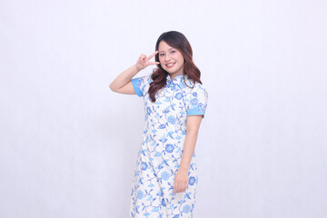 Beautiful smile asian woman wearing modern chinese dress hand signed 2 two isolated on white background. happy Chinese New Year