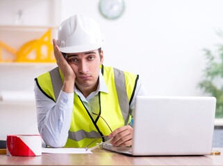 Wall Mural - Young male architect working in the office