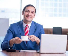 Sticker - Young handsome businessman sitting in the office