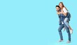 © Pixel-Shot - Stylish young couple in jeans clothes on light blue background with space for text