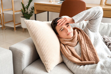 Wall Mural - Sick little boy lying on sofa at home