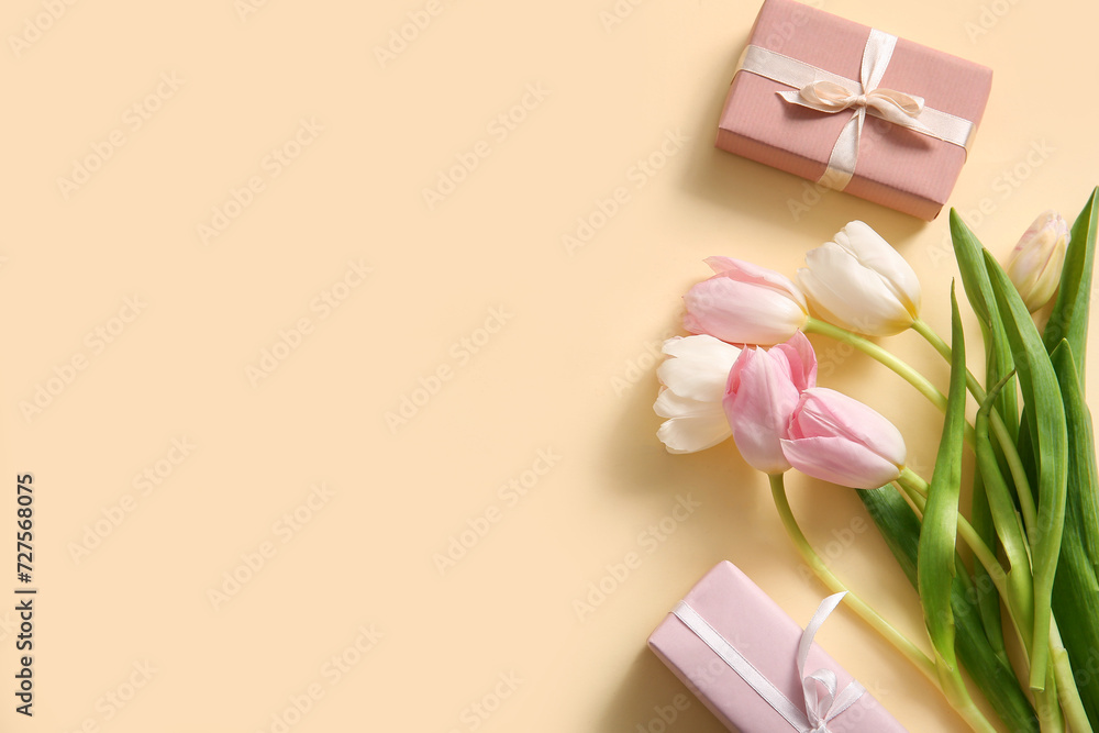 Composition with gift boxes and tulip flowers for Mother's Day celebration on beige background
