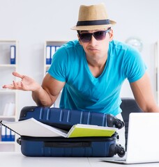 Wall Mural - Businessman preparing for vacation in the office