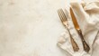 Elegant vintage cutlery set on a textured background with a linen napkin