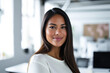 © JuanM - Confident latin businesswoman portrait at her office with copy space