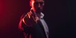 © Irina Ukrainets - Mysterious man pointing forward in a dark room. business style attire with dramatic lighting. perfect for suspense themes. AI