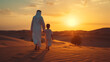 Arab Father and son walking in the desert, Middle-eastern father and son wearing arab traditional kandura spending time in the desert, Dubai,