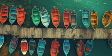 View From Above Of A Dock Surrounded By Many Colorful Boats On A Clear Beautiful Sea Water. 
