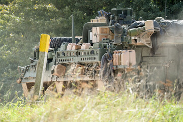 heavily laden USA Stryker 8-wheeled fighting vehicle in motion