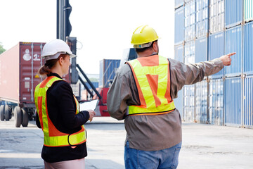 Engineers and employees working at a container warehouse.