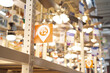 Lighting department with aisle and bay number wide variety of modern ceiling fans blurred bokeh background, price tags, indoor outdoor air circulation, electric home appliance, Dallas, Texas