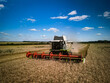 © Юрій Тарасовський - Combine harvesting wheat on the field
