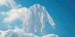 A white shirt is seen hanging from a clothesline against a blue sky backdrop. This image can be used to depict concepts of freshness, cleanliness, laundry, or simplicity