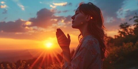 Wall Mural - Woman hands praying for blessing from god on sunset background