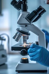 Poster - A close-up view of a person looking through a microscope. This image can be used to depict scientific research, laboratory work, or education