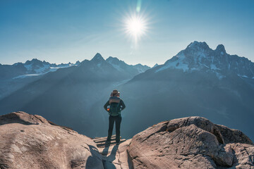 Wall Mural - A female backpacker enjoying the Mont Blanc mountain view during trail of Lac Blanc at France