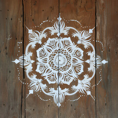 Wall Mural - white rangoli on the wooden surface.