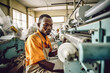 © tong2530 - A male manufacturers african working on production line at plastic bag machine.