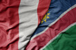 big waving national colorful flag of namibia and national flag of peru .