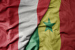 big waving national colorful flag of senegal and national flag of peru .