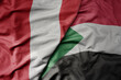 big waving national colorful flag of sudan and national flag of peru .