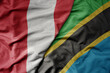 big waving national colorful flag of tanzania and national flag of peru .