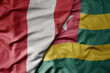 big waving national colorful flag of togo and national flag of peru .