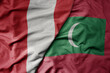 big waving national colorful flag of maldives and national flag of peru .