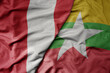 big waving national colorful flag of myanmar and national flag of peru .