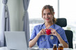 © amnaj - Cheerful young nurse showing a red heart symbol, representing care and compassion in healthcare.