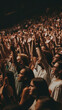 Enthusiastic Audience with Hands Up Captured in Warm Ambient Lighting at a Live Music Event Showing Unity and Excitement