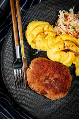 Wall Mural - Minced meat cutlet served with mashed potatoes and salad.