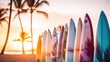 Surfboards on the beach with palm trees and sunset sky background. Surfboards on the beach. Vacation Concept with Copy Space.