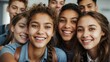 © Tom - A close-up group selfie of happy, multi-ethnic teenagers, with genuine smiles and a sense of close friendship, in a light-filled environment.