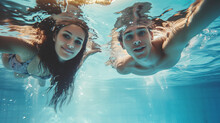 Couple Underwater In Swimming Pool