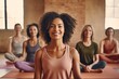 A cheerful yoga instructor stands confidently at the forefront, with her contented students seated in the lotus position in the background, all enjoying a calm and tranquil yoga studio atmosphere