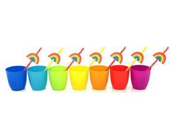 Rainbow drinking cups with eco friendly paper straws on white background. Minimal decorative colorful design abstract with trans LGBT and environmentally friendly theme