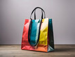 Multicoloured paper glossy shopping bag mockup design with black handles designs.
