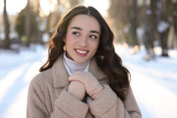 Wall Mural - Portrait of smiling woman in snowy park