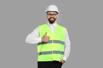 Sticker - Engineer in hard hat showing thumb up on grey background