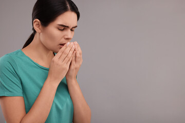 Sticker - Woman coughing on grey background, space for text. Cold symptoms