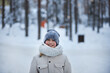 © justoomm - Young Girl Smiles While Walking in Snow