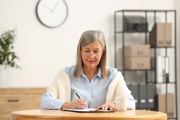 Poster - Senior woman signing Last Will and Testament at table indoors