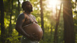 Heavily pregnant transgender african american man with tattoos. Proud LGBTQ+ pregnant man. AI generated