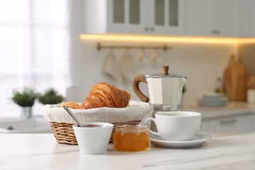 Sticker - Breakfast served in kitchen. Fresh croissants, jam, honey and coffee on white table